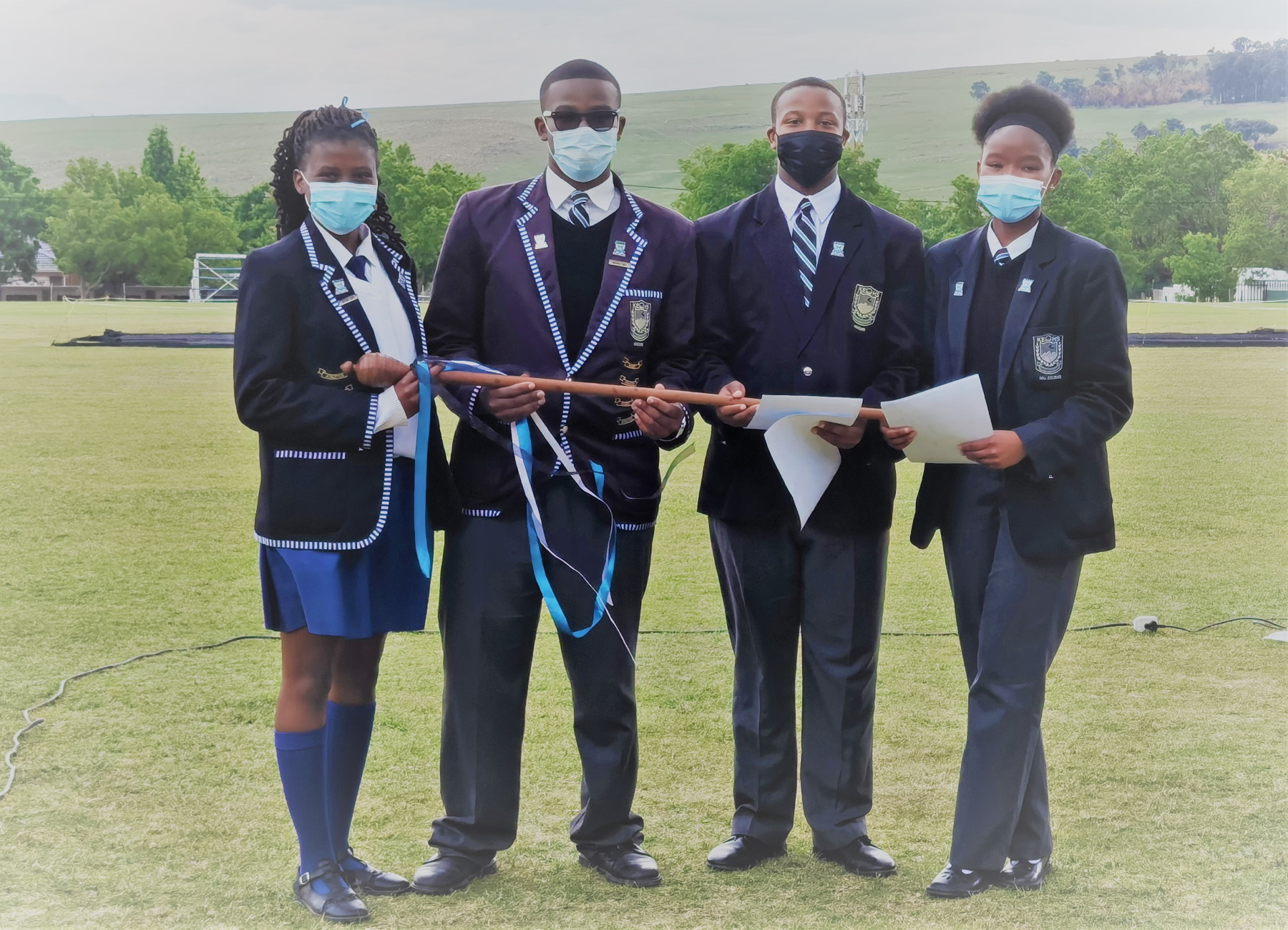 Outgoing Head Prefects Rebecca and Sinelizwi handing the mace of authority to 2022s Head Prefects Rendani and Aviwe